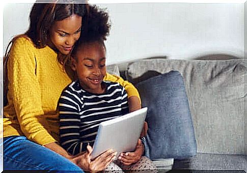 mother and daughter learning on a tablet