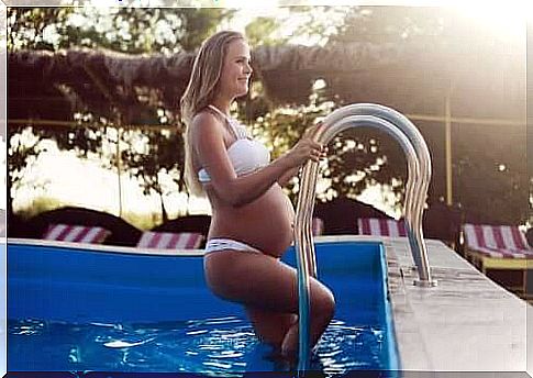 A pregnant woman comes out of the swimming pool