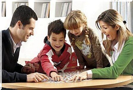 Parents playing a board game with their children