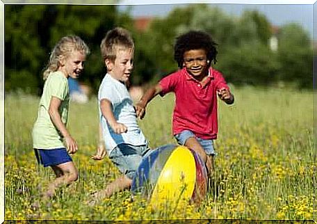 Children playing ball outside.