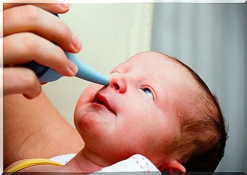 Nasal aspirator into a baby's nose as they cannot breathe through their mouths