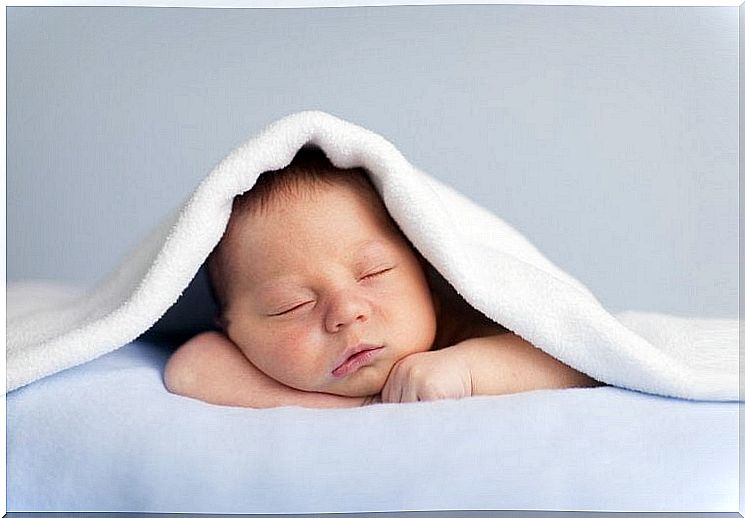 Baby asleep under a blanket