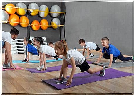 Children in sports session in a gymnasium. 