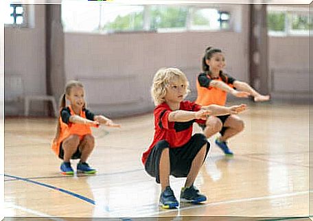 Three kids doing squats. 