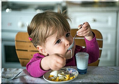 child eating yogurt