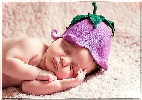 A sleeping baby with a beanie