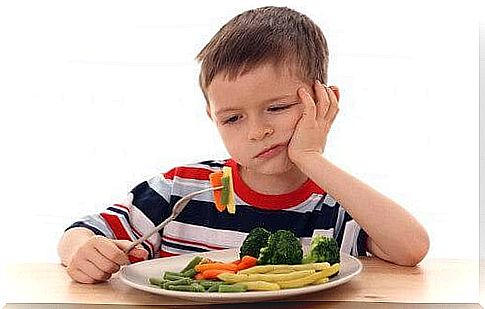 A child does not want to eat his vegetables