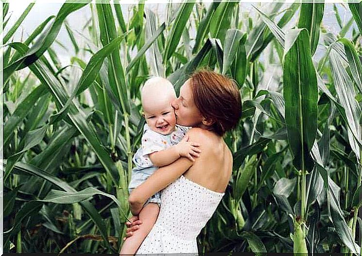 A mother kissing her baby.