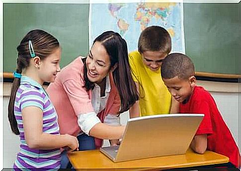 teacher and students around a computer