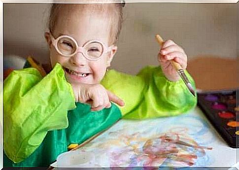 young girl with intellectual disability painting