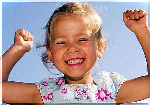 little girl raising her arms