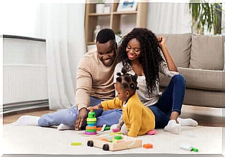 Two parents playing with their little girl. 