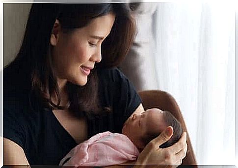 woman with her postpartum baby