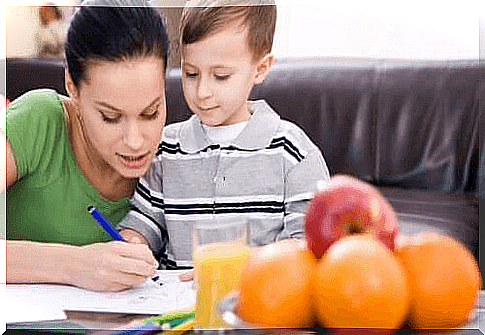 mother and son doing school homework together