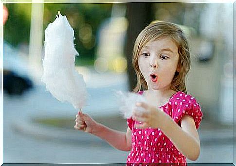 A girl eats cotton candy