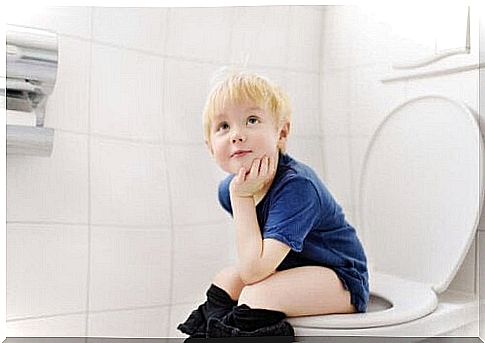 A child on the toilet. 