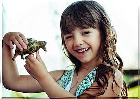 girl holding a turtle