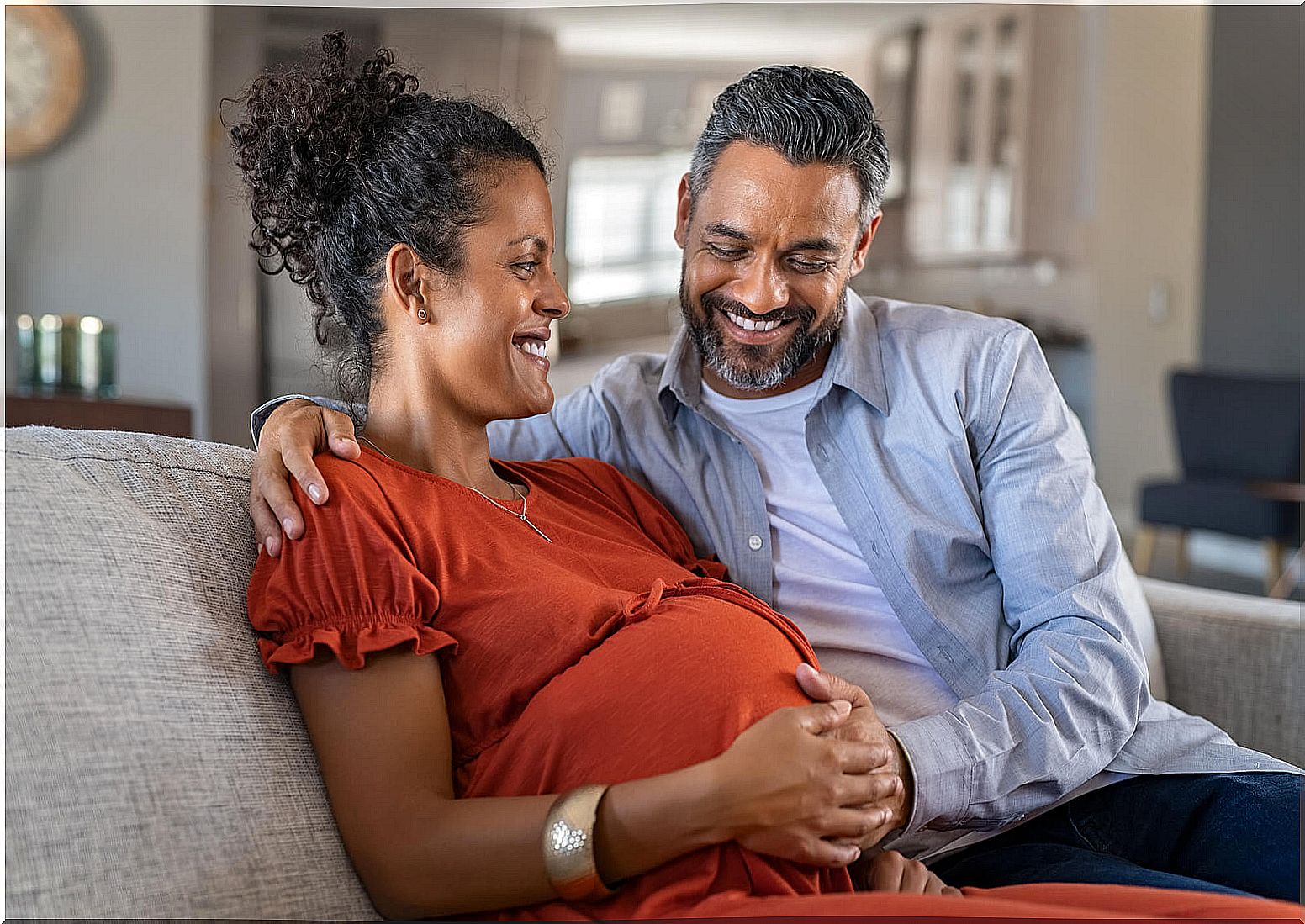 A pregnant woman and her happy partner. 