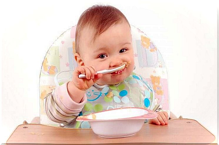 A baby eating from a spoon