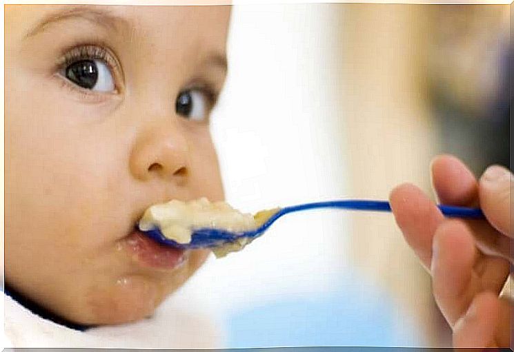 A baby eating porridge